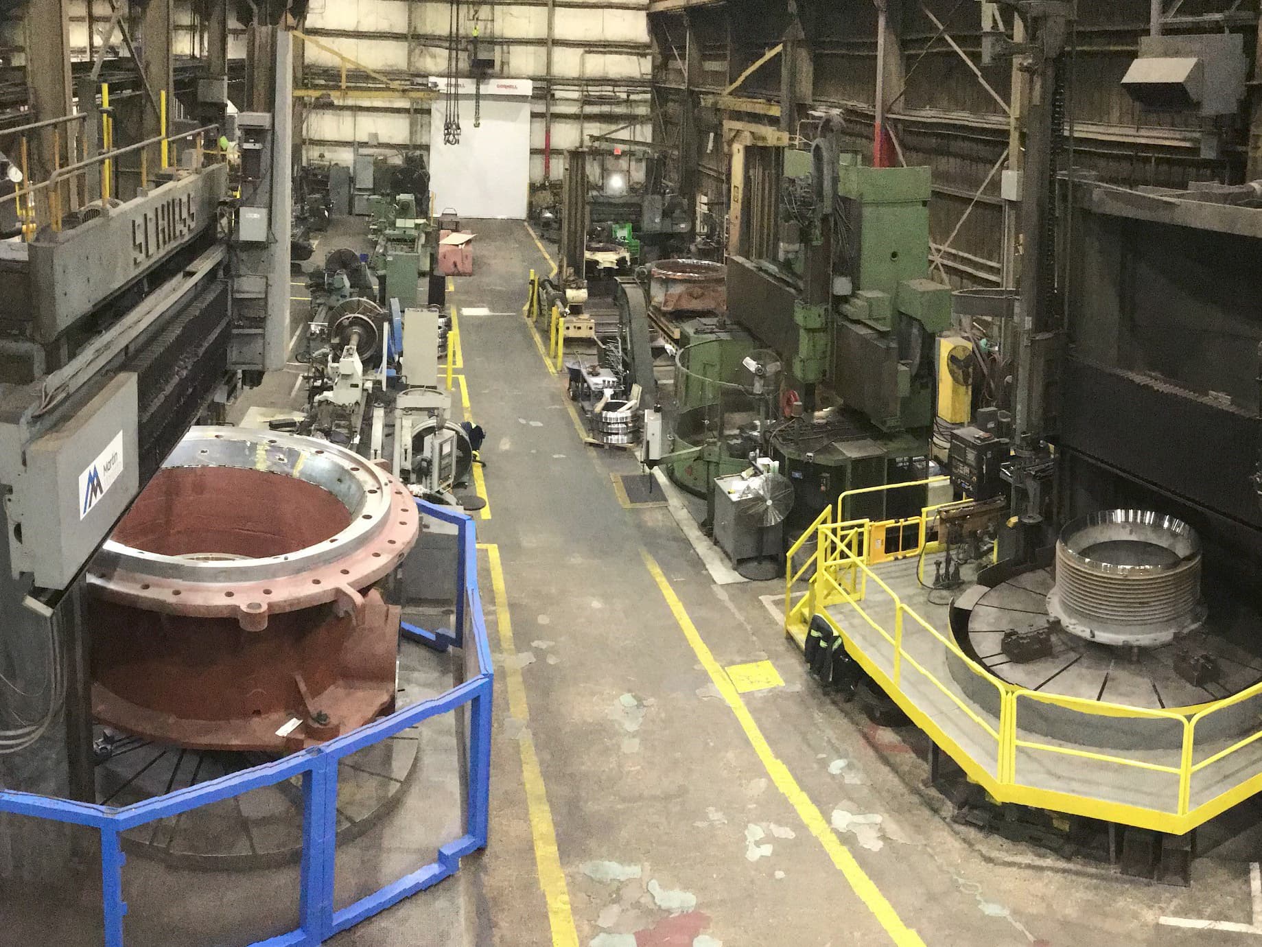 Safety improvements at Salisbury in 2020 were the installation of machine guarding and safety interlocks to the team’s vertical boring mills, including its 14’ mill (in blue left), its 12’ mill (in yellow right), and it’s 10’ mill (at right in green).