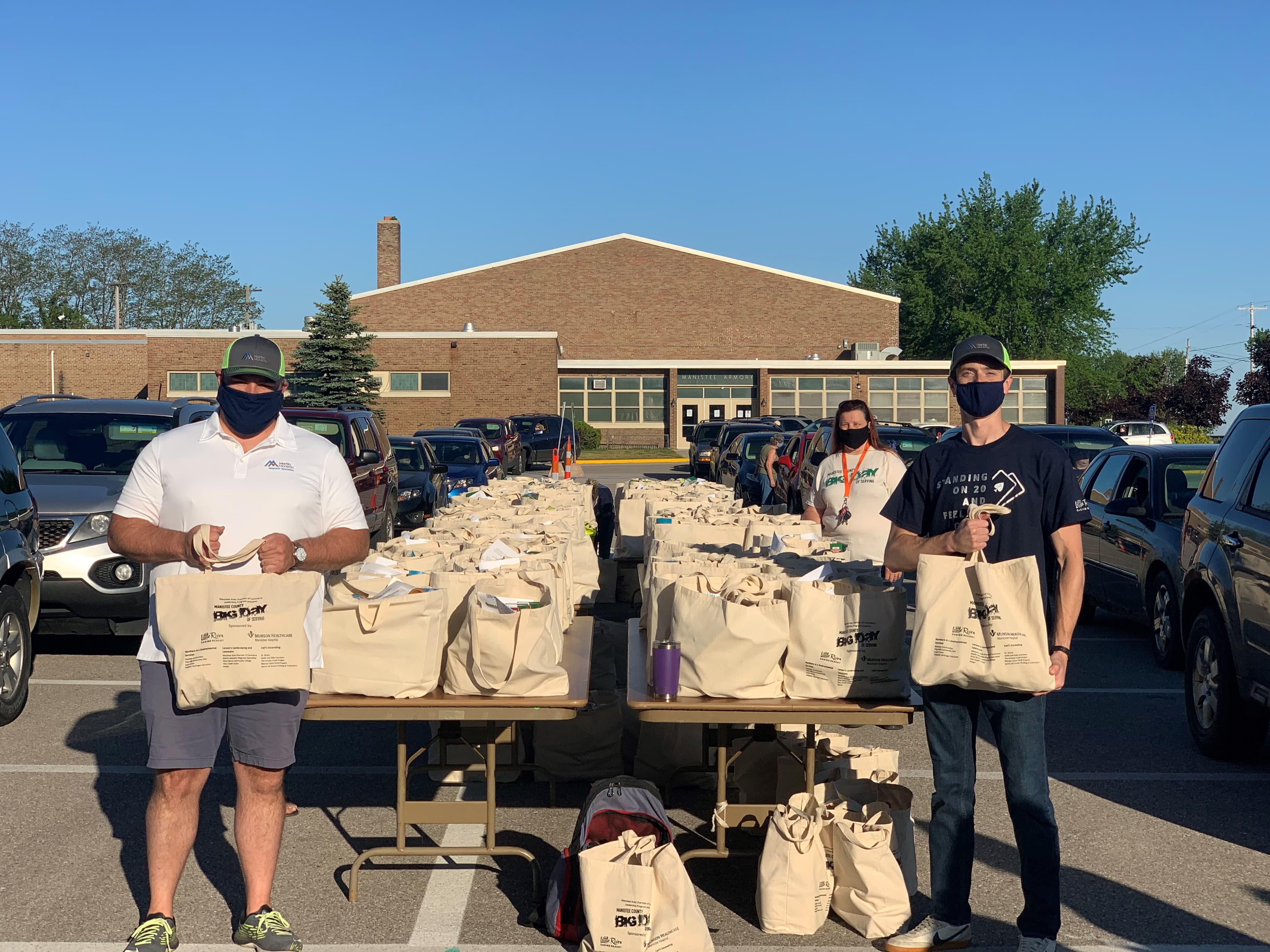 Brett Ballard (left) and Kris Kacynski worked alongside 10 members of the Manistee Area Chamber of Commerce’s Leadership Program to distribute 6,500 pounds of food to more than 260 families in need.