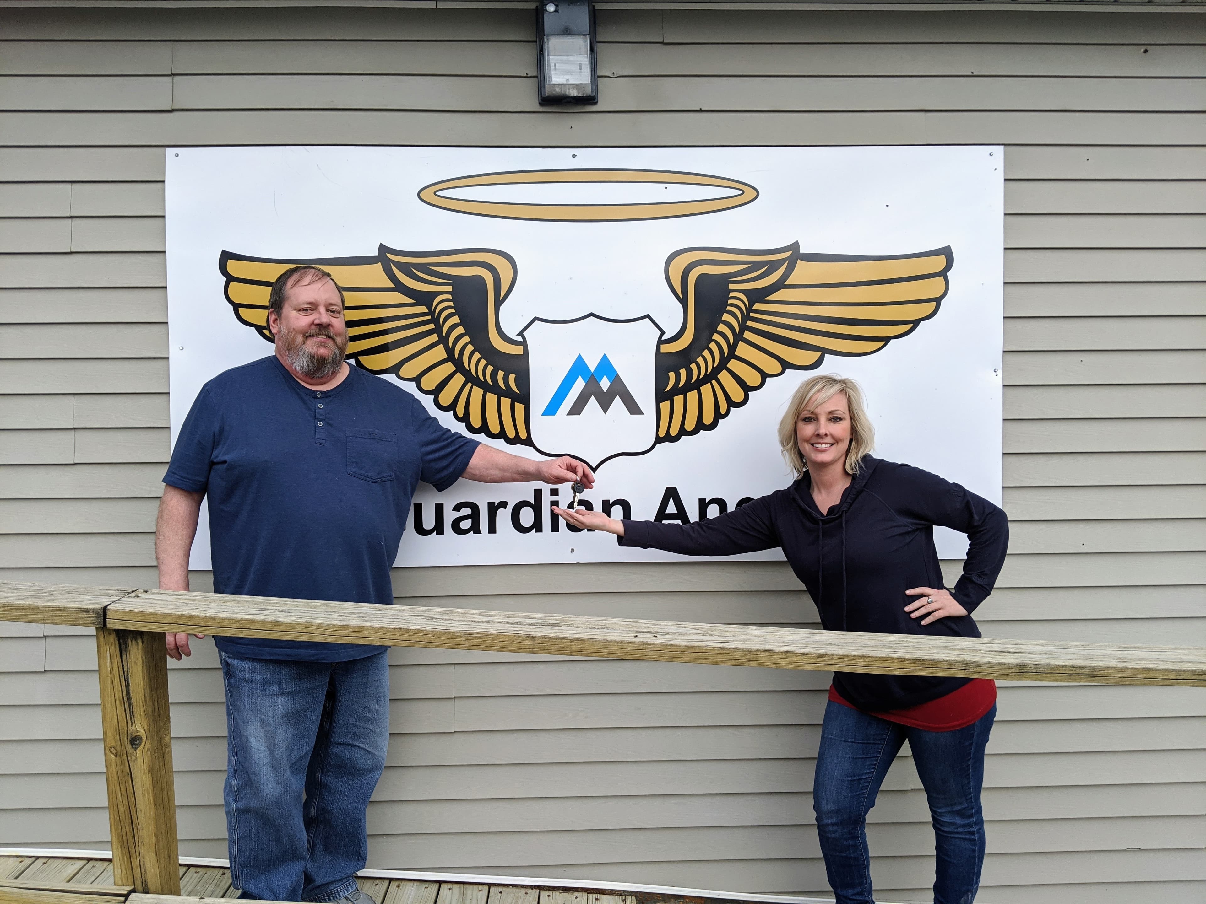 Senior Clerk Joel Tichy hands over the keys to Ferguson Quarry to his daughter, Lisa Tichy.