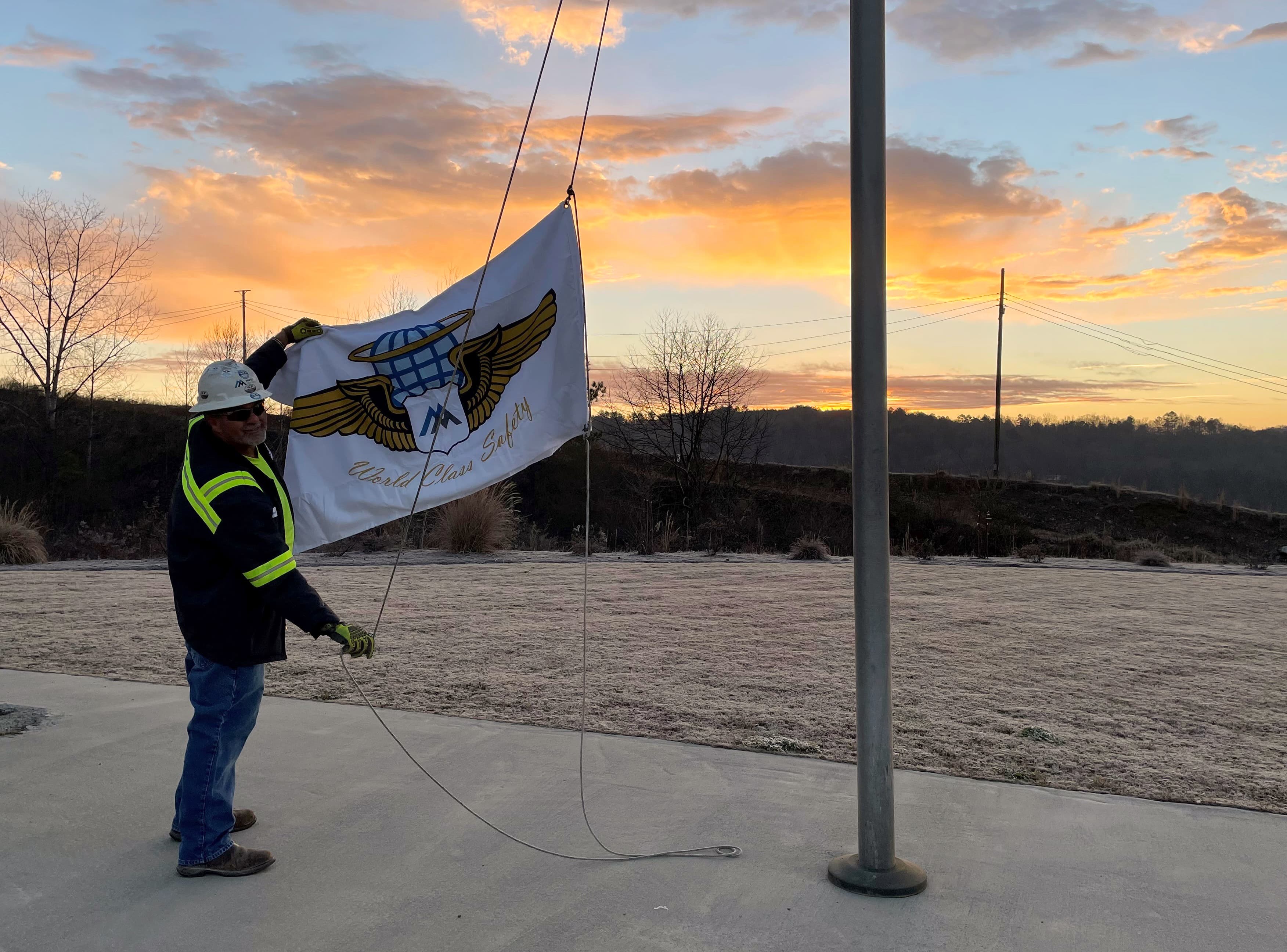 Yard Loader Operator David Maxie raises a world-class safety flag over Ball Ground Quarry.