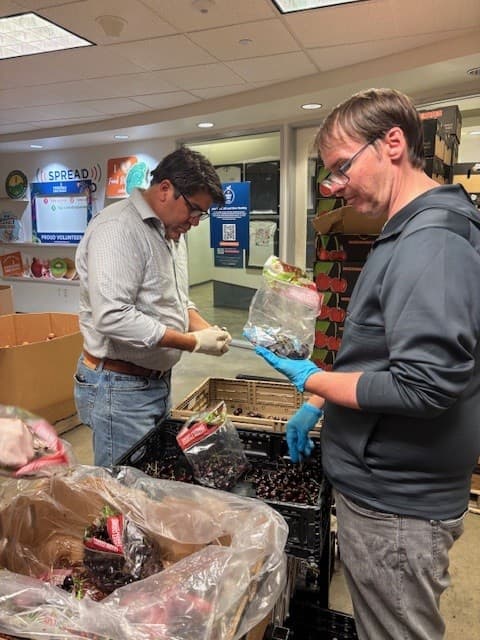 David Seguin (right) and Tom Lavera examine cherries that will be distributed to those facing hunger in the San Diego area