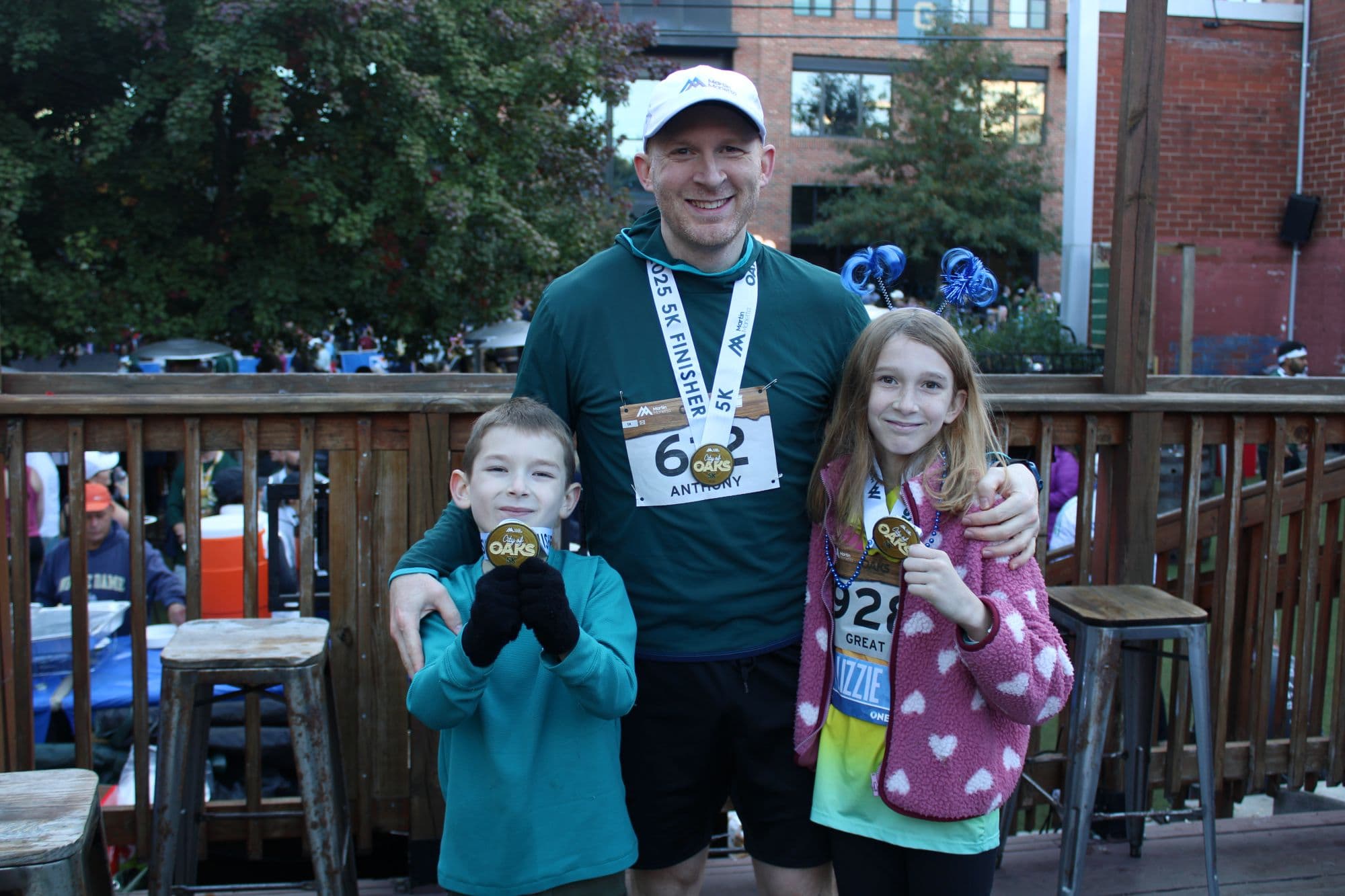 TJ Volpe, along with his children, Anthony and Lizzie, pose with their medals after running their races.