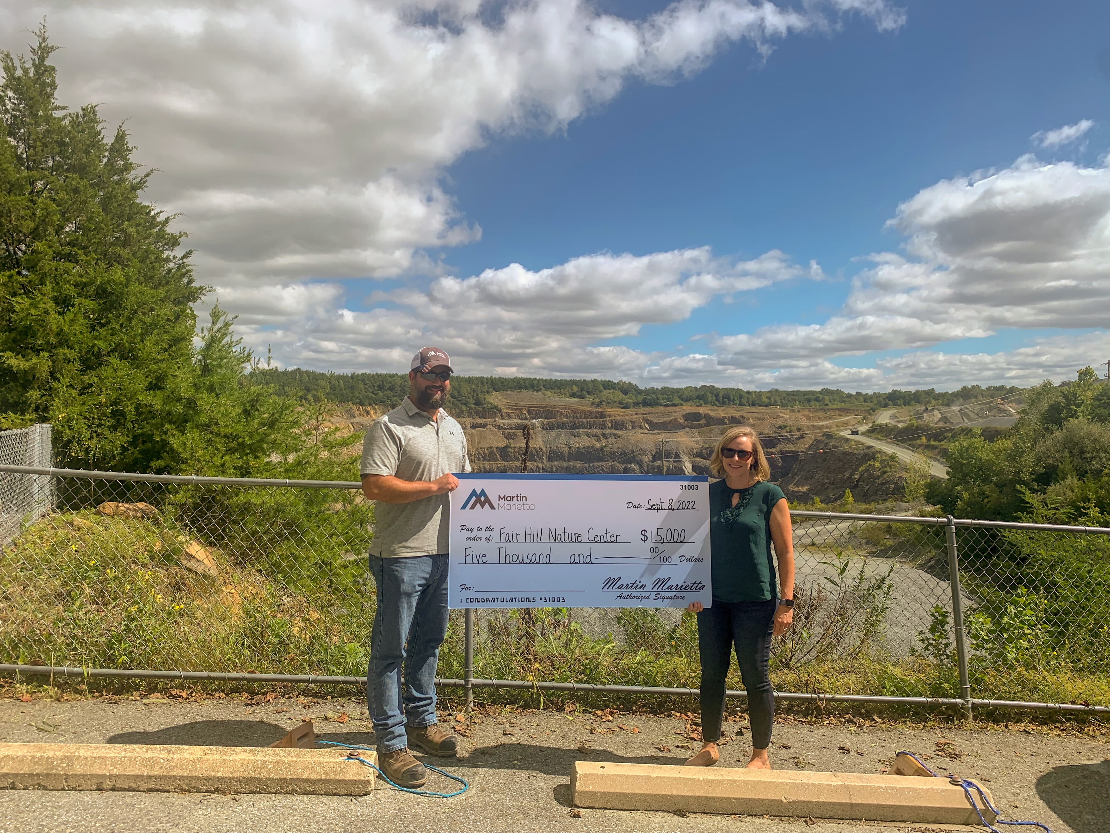 Kevin Cantalupo, North East Quarry plant manager, presents a $5,000 check to Laura Hannan, executive director of the Fair Hill Nature Center, in support of outdoor education programs for elementary-age students.