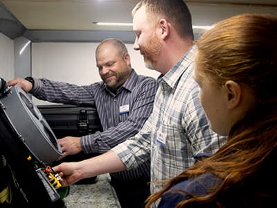 Indiana District Senior Safety Representative Dave Metcalf (left) teaches Assistant Plant Manager Charles Waychoff and Underground Mine Foreman Caitlin Darnall (both from North Indianapolis Mine) about the equipment used by the district’s Mine Rescue Team.