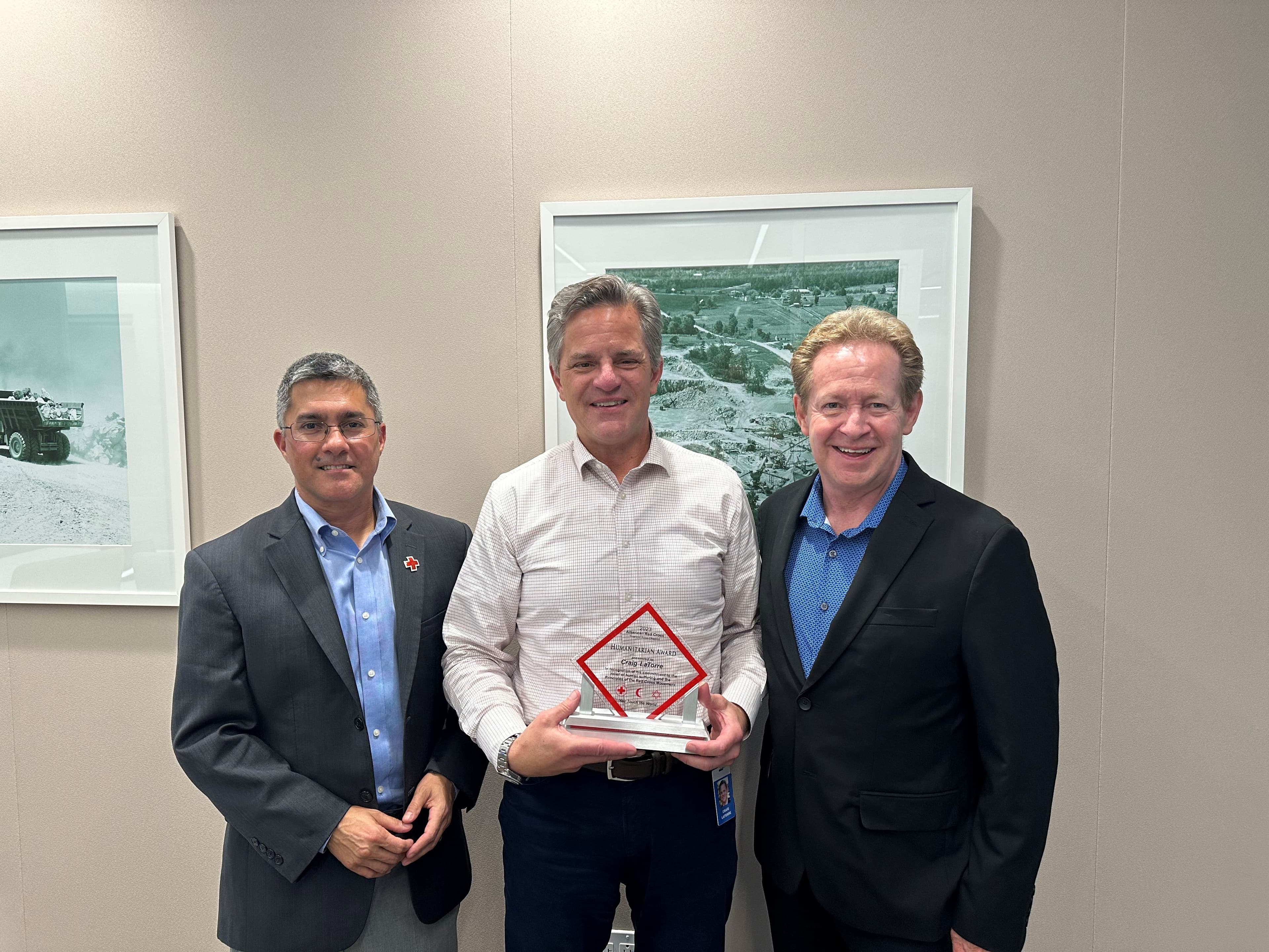 Chief Human Resource Officer Craig LaTorre (center) receives the American Red Cross North Carolina Region’s 2023 Humanitarian Award presented by Philanthropy Officer Dileep Dadlani (left) and retired regional CEO Barry Porter (right).