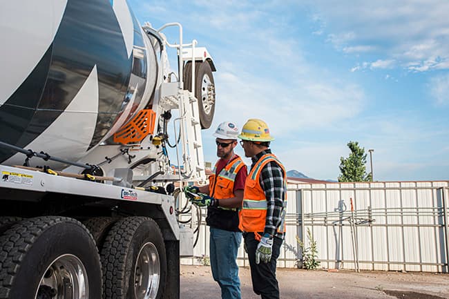 Chris Hill (left), a mentor at Highway 85 Ready Mix in Colorado, works with Mentee Richard Adame.