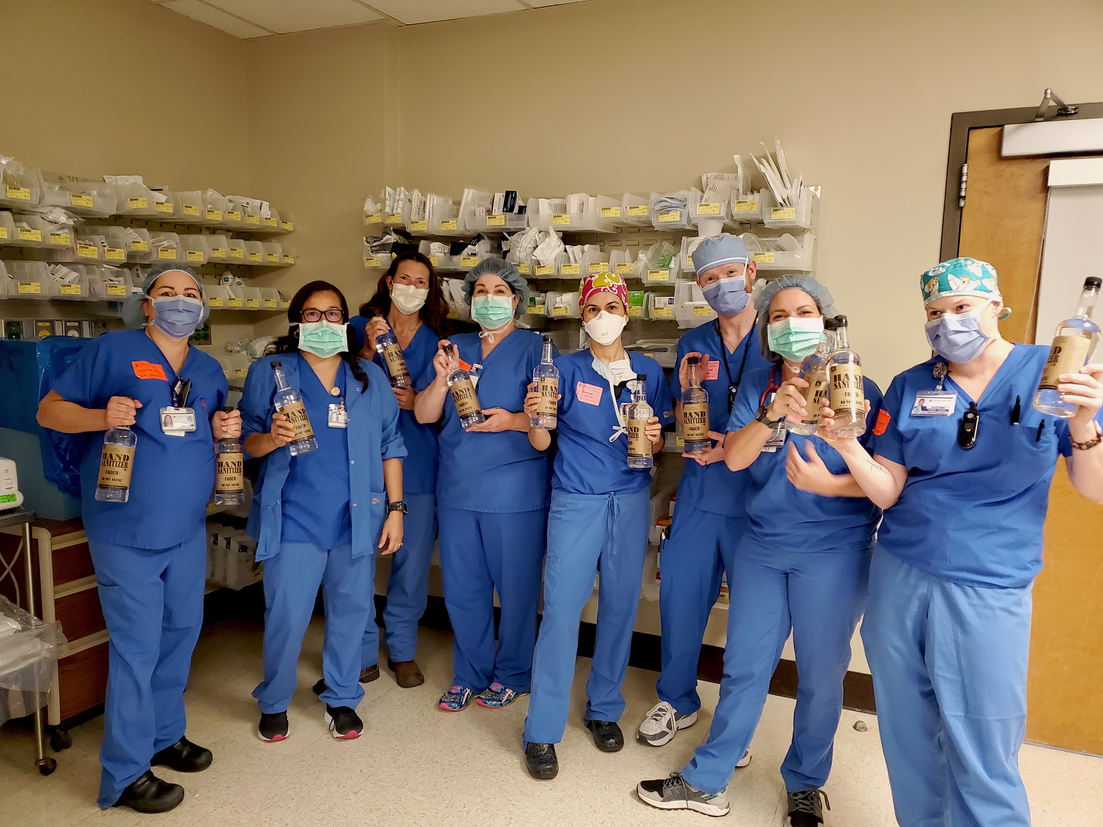 Nurses at CHRISTUS Santa Rosa Hospital in New Braunfels, Texas, pose with donated bottles of hand sanitizer.
