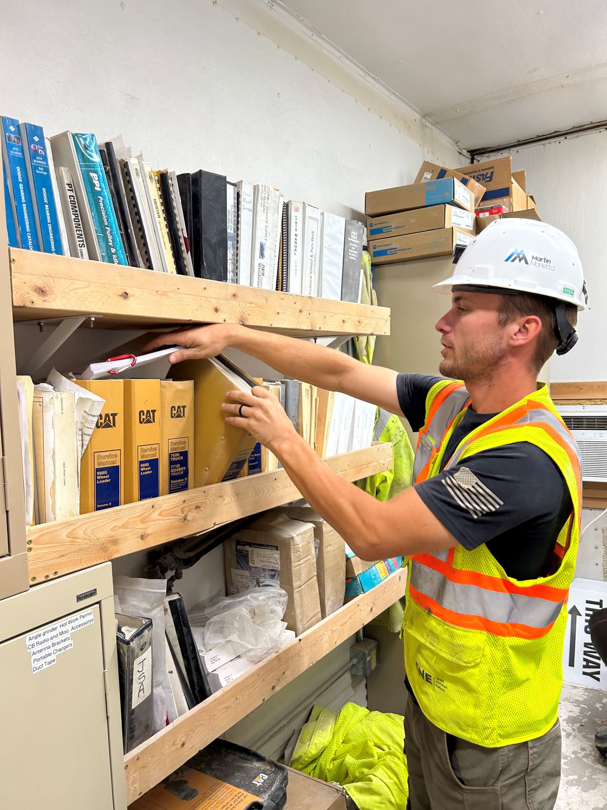 Jacob Newquist, plant manager of Des Moines Portable, reviews service manuals for the site’s equipment