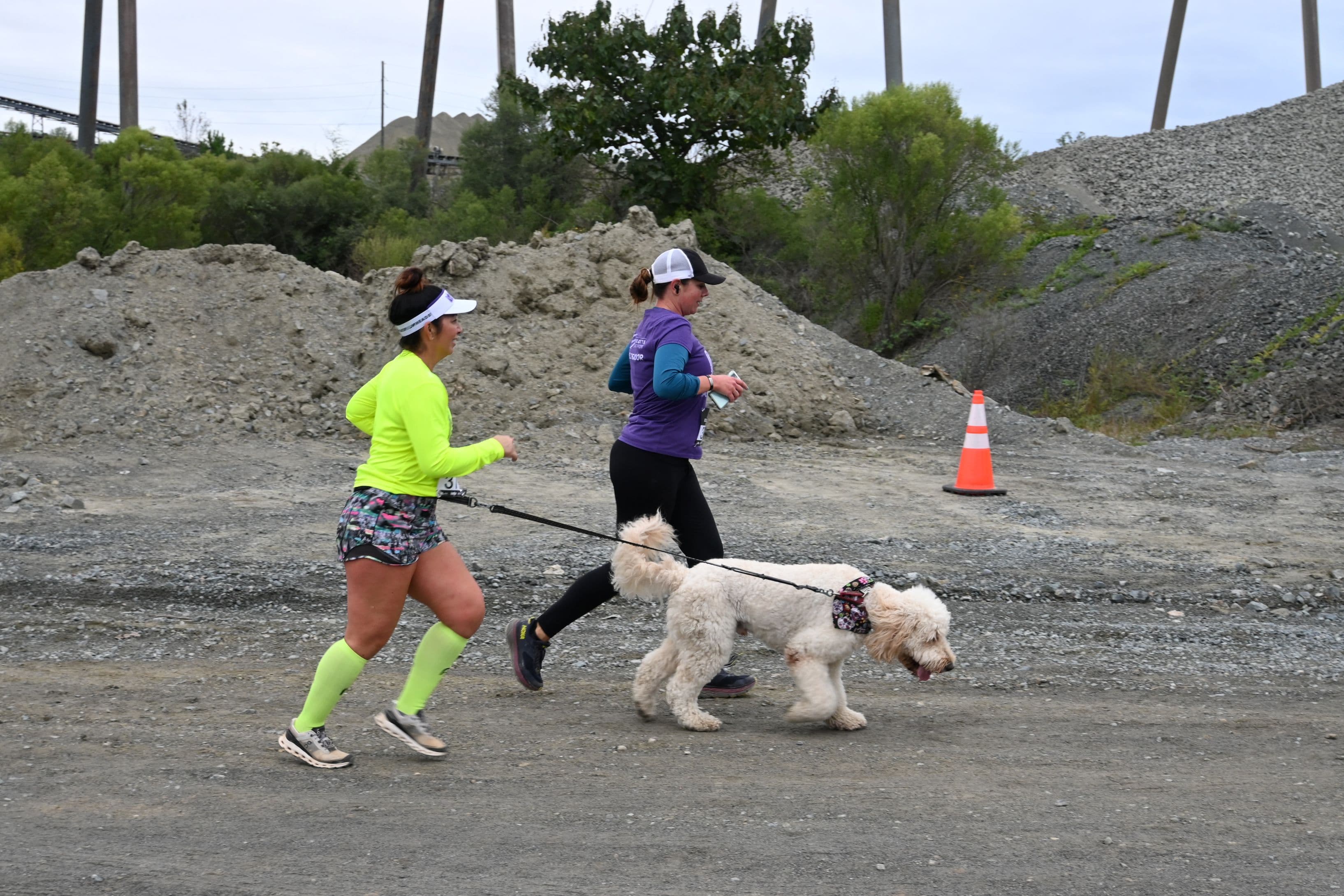 Runners and their four-legged friend trek through the challenging course at Charlotte Quarry.