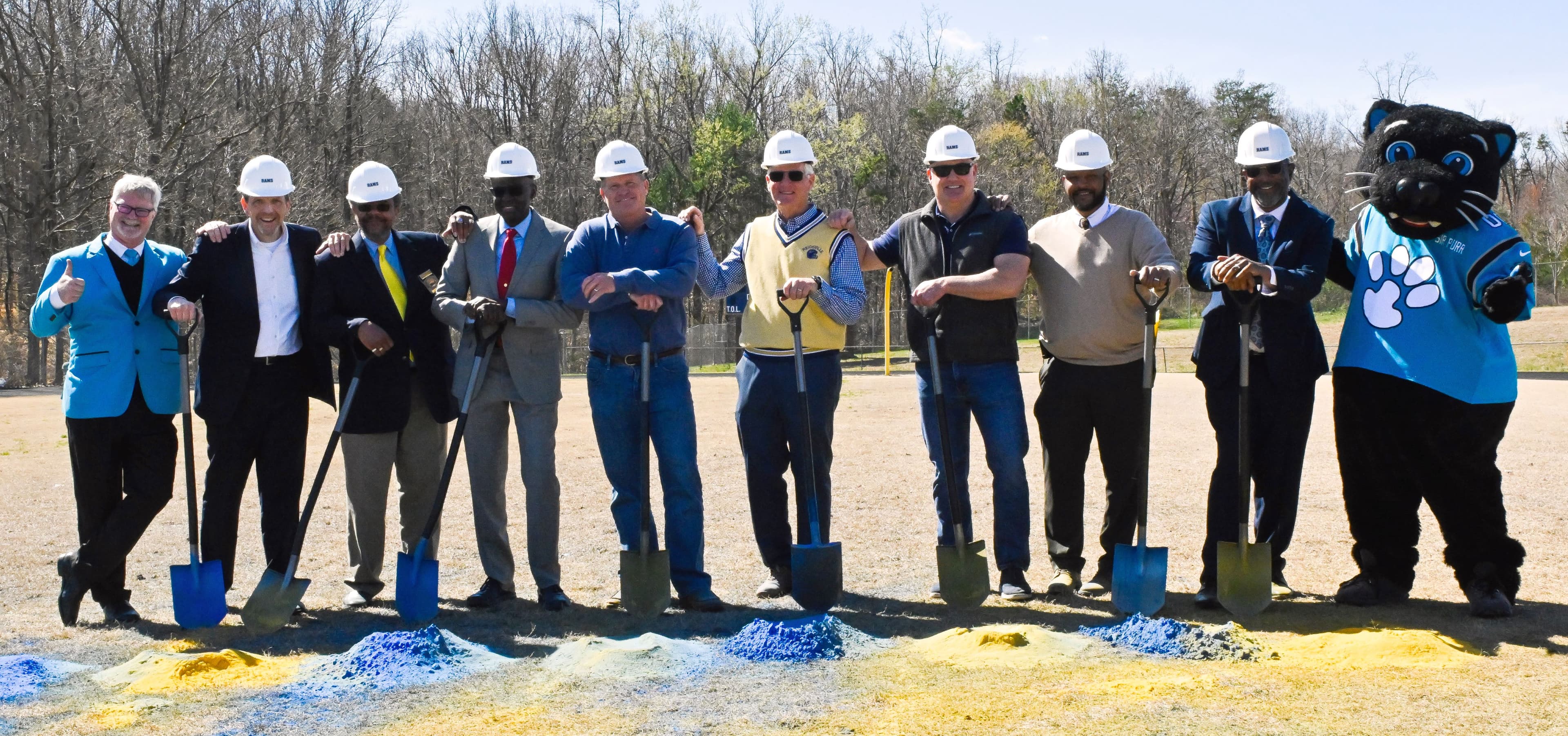 Martin Marietta Area Sales Manager Scotty Crouse (center, right in a black shirt) helps break ground with community leaders and Carolina Panther staff at Reidsville High School.