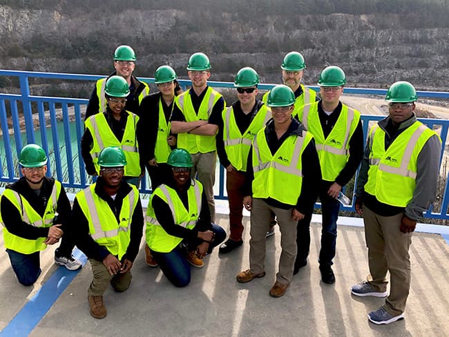 A group from Heroes MAKE America pause for a group photo while touring Pomona Quarry in Greensboro, North Carolina.