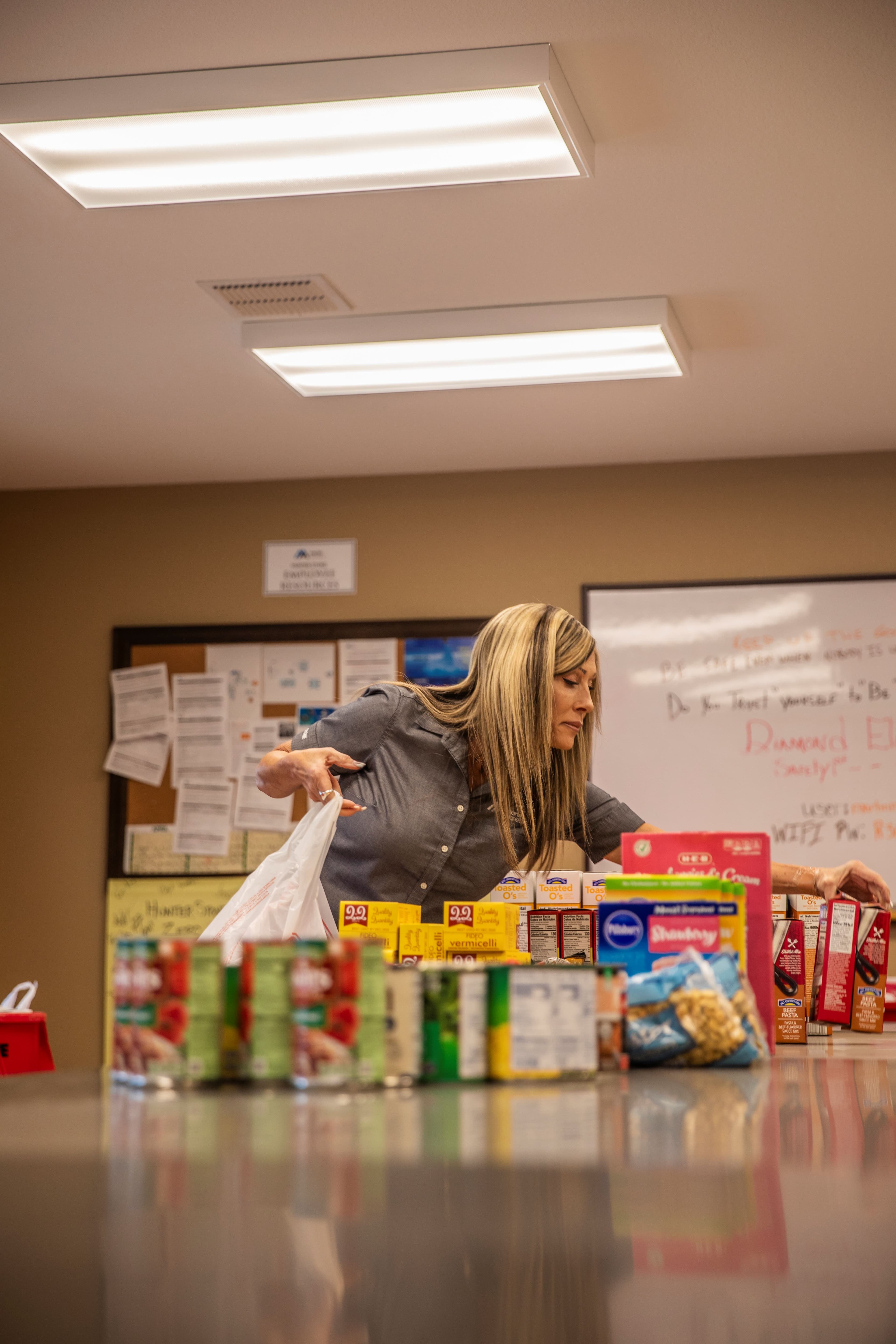 Lisa Rogers organizes donations during one of the team’s many food drives.