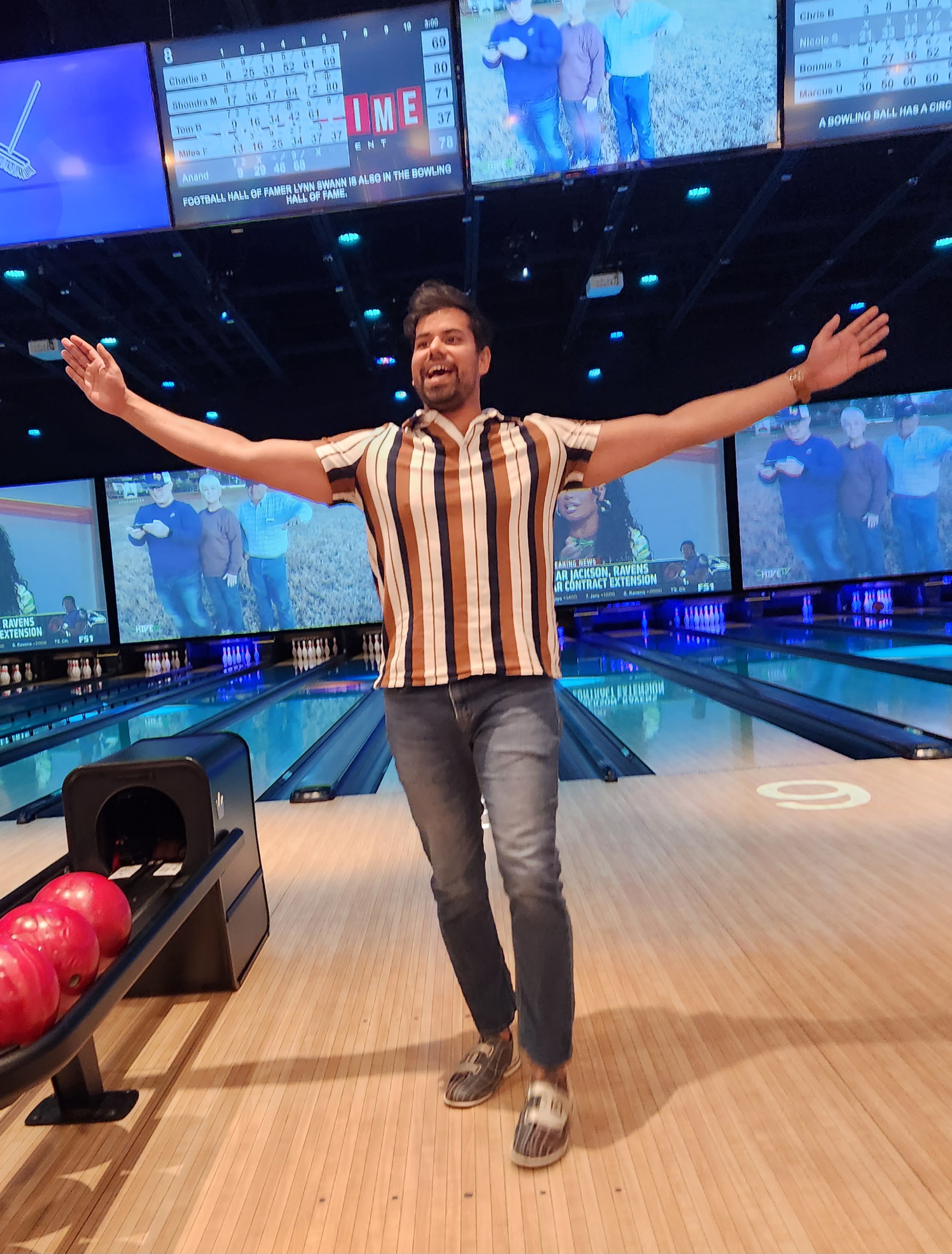 Anand Kumar, a district engineer, celebrates bowling a strike at the charity bowling event.